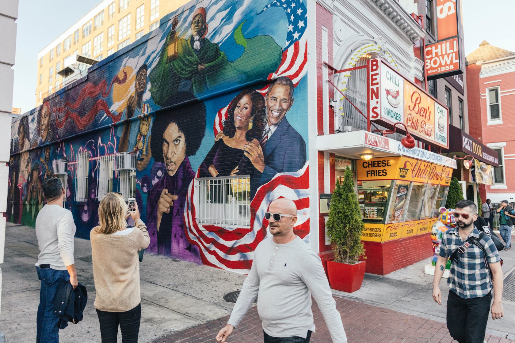 Guests Taking Photo of Ben's Chili Bowl Mural