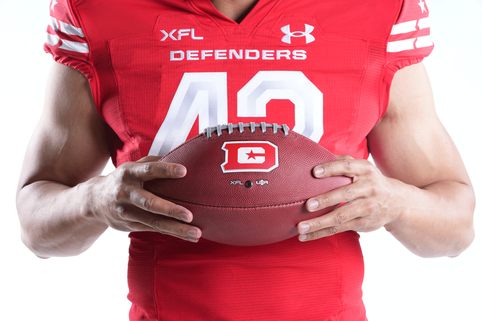 close up photo up DC Defender holding a football