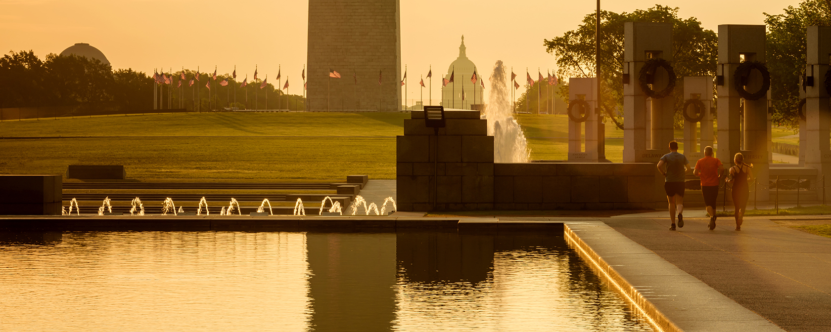 Group of people running beside Reflecting Pool on National Mall