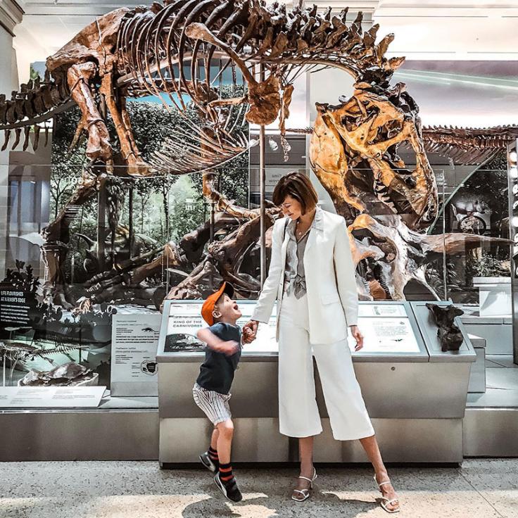 Mother and son standing in front of dinosaur skeleton at National Museum of Natural History