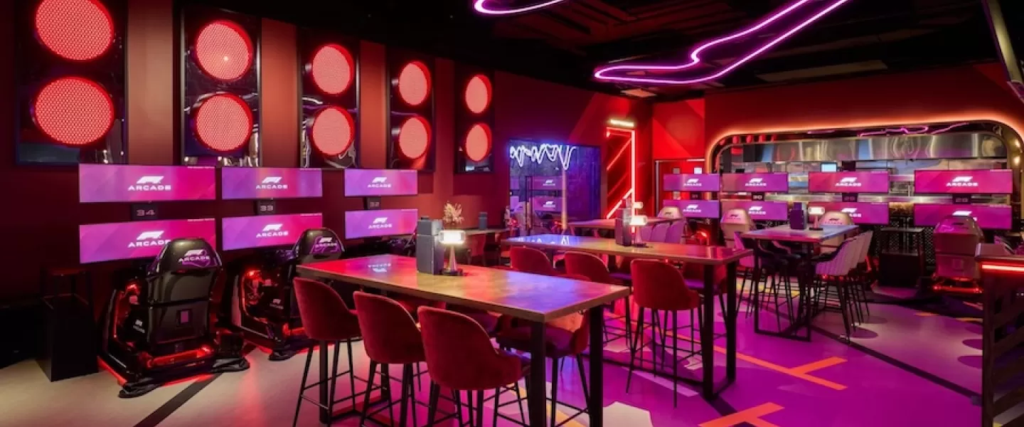 A futuristic racing arcade in Washington, DC, featuring neon lighting, F1-inspired decor and immersive gaming stations.