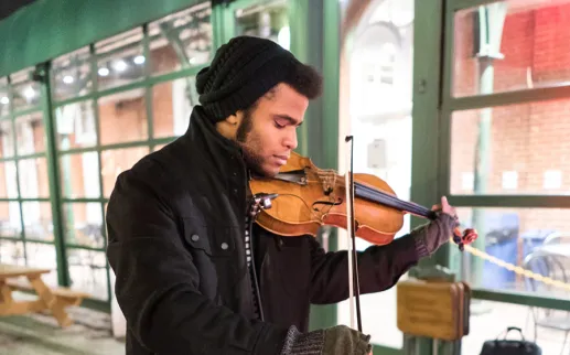 Man playing Violin in Cold Weather
