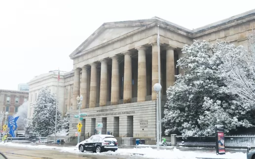 The National Portrait Gallery's grand facade dusted with a layer of fresh snow in Washington, DC.
