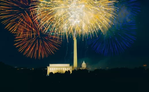 Colorful fireworks light up the night sky over the Washington Monument, Lincoln Memorial, and U.S. Capitol in Washington, DC, during a Fourth of July celebration.
