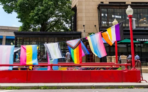 A string of LGBTQ+ flags hang from a former Metro stop in Dupont Circle. 