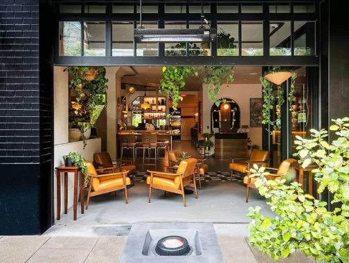 indoor/outdoor patio space with plants, chic outdoor furniture, and a fire pit at Eaton DC