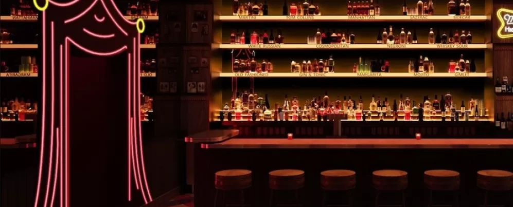 A dimly lit, retro-style bar with a backlit liquor display, a row of wooden stools and a neon pink curtain-shaped entrance on the left.