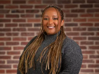 A woman smiles for a professional headshot. 