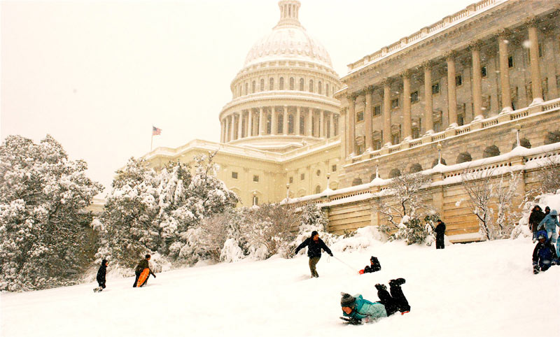 Sledding on Capitol Hill in front of the U.S. Capitol - Snow day activities in Washington, DC