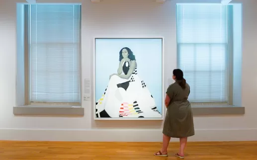 A woman gazes at a stylized portrait of Michelle Obama at the Smithsonian American Art Museum. 
