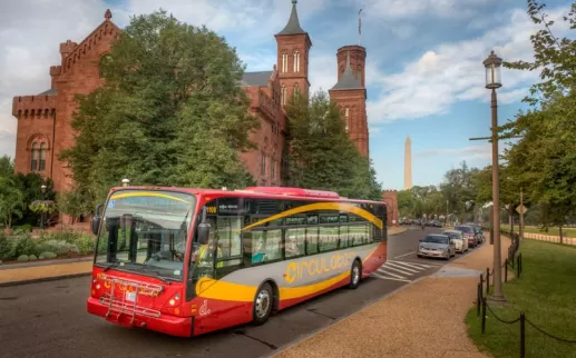 DC Circulator bus on the National Mall in front of the Smithsonian Castle - How to get around Washington, DC
