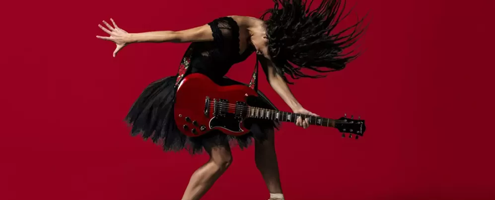 Picture of Woman strumming guitar and dancing ballet