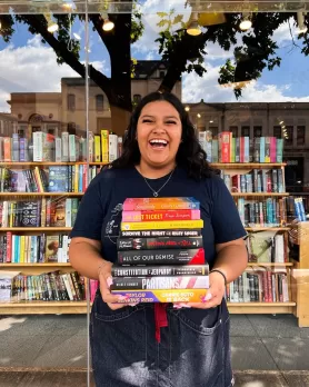 Smiling woman holding books