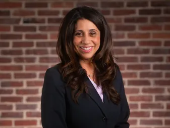 A woman smiles for a professional headshot. 